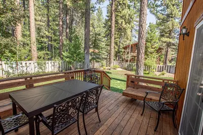 a wooden deck with a table and a bench on it at Dollar Point Lodge By Hauserman Rentals in Tahoe City