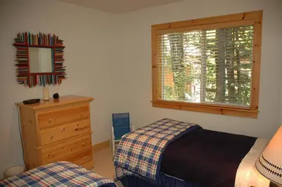 a bedroom with a bed and a dresser and a window at Going By Hauserman Rentals in Homewood