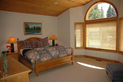 a bedroom with a bed and a large window at Going By Hauserman Rentals in Homewood
