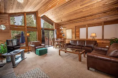 a living room with leather couches and a television at Vance By Hauserman Rentals in Tahoe City