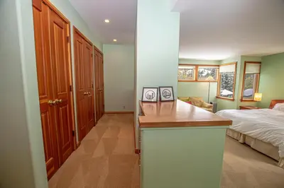 a bedroom with a bed and a kitchen with a counter at Snow Crest By Hauserman Rentals in Alpine Meadows