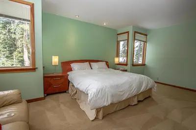 a bedroom with a large bed and a couch at Snow Crest By Hauserman Rentals in Alpine Meadows