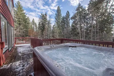 a hot tub on the deck of a house at Highlands Lodge By Hauserman Rentals in Tahoe City