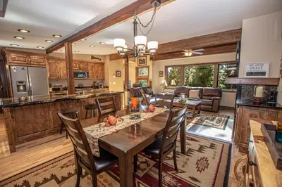 a kitchen and living room with a wooden table and chairs at Black Bear Haus By Hauserman Rentals in Tahoe City