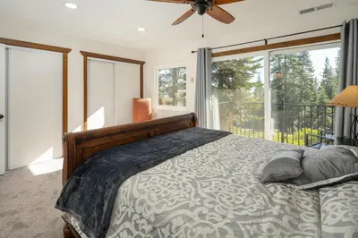 a bedroom with a bed and a large window at Carnelian Woods #126 By Hauserman Rentals in Carnelian Bay