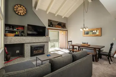 a living room with a couch and a table and a fireplace at Carnelian Woods #126 By Hauserman Rentals in Carnelian Bay