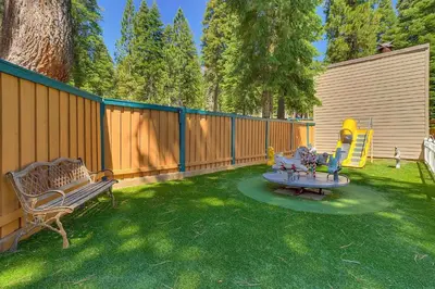 a backyard with a bench and a playground at Carnelian Woods #126 By Hauserman Rentals in Carnelian Bay
