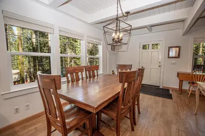 a dining room with a wooden table and chairs at Hillhouse By Hauserman Rentals in Homewood