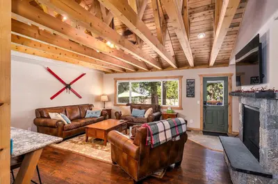 a living room with leather furniture and a fireplace at Cedarwood Serenity By Hauserman Rentals in Tahoe City