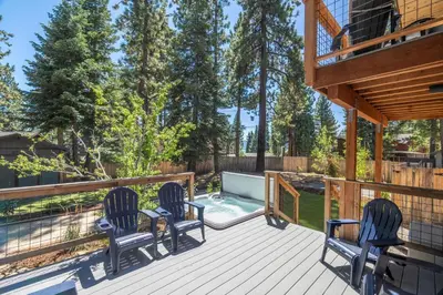 a deck with two chairs and a swimming pool at Cedarwood Serenity By Hauserman Rentals in Tahoe City