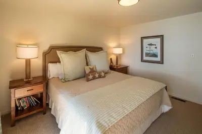 a bedroom with a large bed with two night stands and two lamps at McCown Lakefront By Hauserman Rentals in Tahoma
