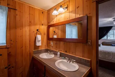 a bathroom with two sinks and a mirror at Molly's Treehouse By Hauserman Rentals in Carnelian Bay