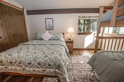 a bedroom with a bed and a bunk bed at Casa Pasquale By Hauserman Rentals in Carnelian Bay