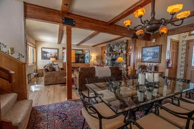 a dining room and living room with a glass table at Rygh Lakefront By Hauserman Rentals in Carnelian Bay