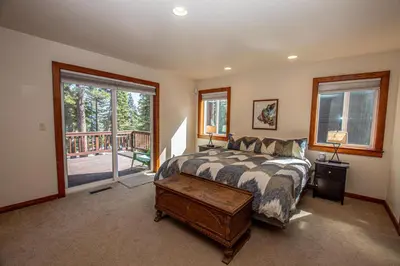 a bedroom with a bed and a large window at Tahoe Haven By Hauserman Rentals in Carnelian Bay