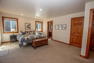 a bedroom with a bed and a wooden door at Tahoe Haven By Hauserman Rentals in Carnelian Bay
