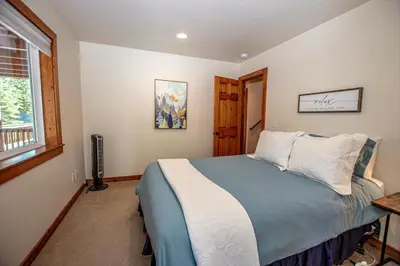 a bedroom with a bed and a window at Tahoe Haven By Hauserman Rentals in Carnelian Bay