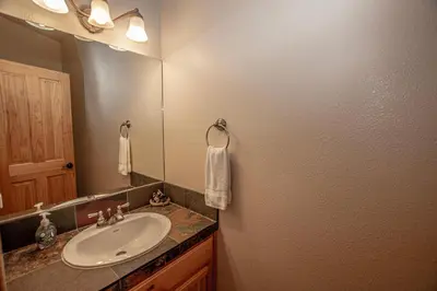 a bathroom with a sink and a mirror at Sherman By Hauserman Rentals in Tahoma