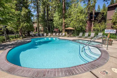 a swimming pool with a slide in a resort at St Francis #53 By Hauserman Rentals in Tahoe City