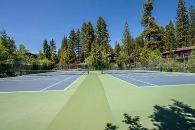 a tennis court with two tennis rackets on it at St Francis #53 By Hauserman Rentals in Tahoe City
