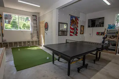 a ping pong table in a room with a green rug at Eagle Pines By Hauserman Rentals in Tahoe City