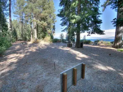 a fence in the middle of a field with trees at Eagle Pines By Hauserman Rentals in Tahoe City