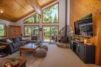 a living room with a couch and a tv and a fireplace at Eagle Pines By Hauserman Rentals in Tahoe City