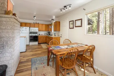 a kitchen and dining room with a table and chairs at Squirrels Nest By Hauserman Rentals in Carnelian Bay