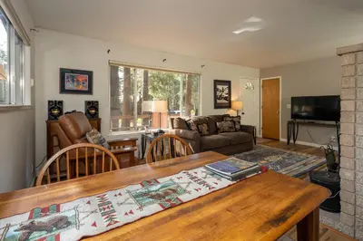 a living room with a table and a couch at Squirrels Nest By Hauserman Rentals in Carnelian Bay
