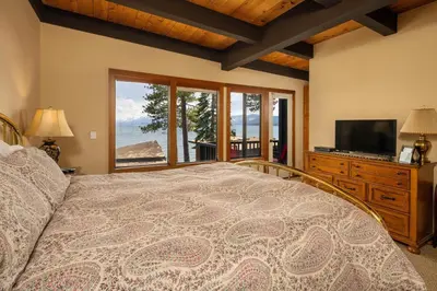 a bedroom with a bed and a tv and a window at Star Harbor # 4 By Hauserman Rentals in Tahoe City