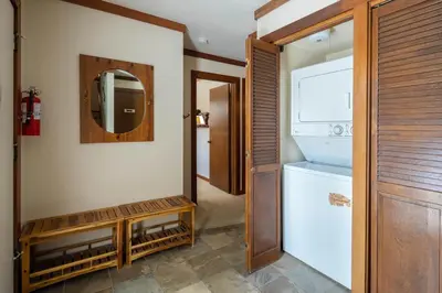 a bathroom with a refrigerator and a mirror at St Francis #14 By Hauserman Rentals in Tahoe City