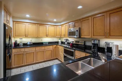 a kitchen with wooden cabinets and stainless steel appliances at Star Harbor # 15 By Hauserman Rentals in Tahoe City