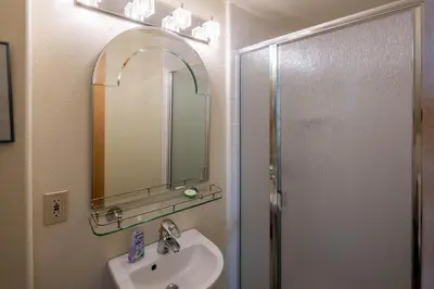a bathroom with a sink and a mirror and a shower at Star Harbor # 15 By Hauserman Rentals in Tahoe City