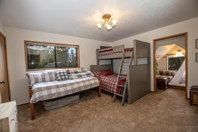 a bedroom with two beds and a bunk bed at Tahoma Treasures Emerald Cabin Hauserman Rentals in Tahoma