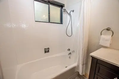 a white bathroom with a tub and a shower at Tahoma Treasures Emerald Cabin Hauserman Rentals in Tahoma