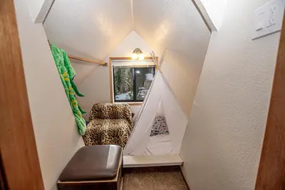 a tiny house with a room with a window at Tahoma Treasures Emerald Cabin Hauserman Rentals in Tahoma