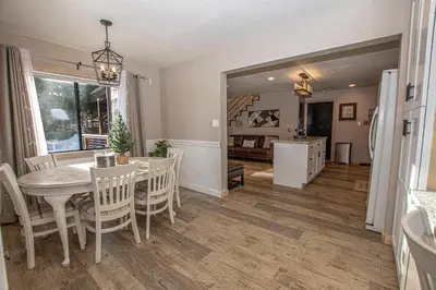 a dining room and living room with a table and chairs at Tahoma Treasures Emerald Cabin Hauserman Rentals in Tahoma