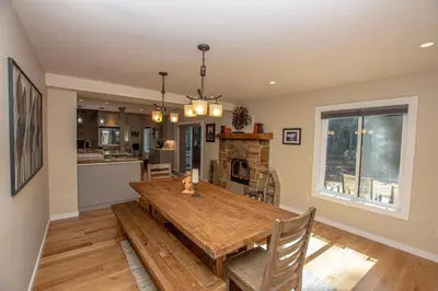 a kitchen and dining room with a wooden table at Stephens Retreat By Hauserman Rentals in Carnelian Bay