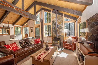 a living room with a couch and a table at Thunder Lodge By Hauserman Rentals in Homewood