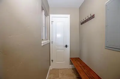 a hallway with a white door and a window at Weathertop By Hauserman Rentals in Tahoe City