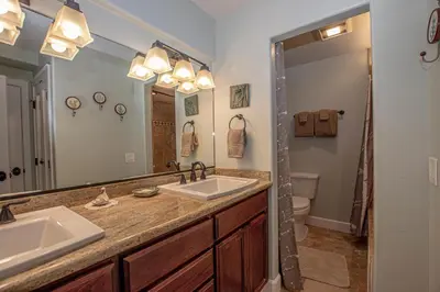 a bathroom with two sinks and a large mirror at Weathertop By Hauserman Rentals in Tahoe City