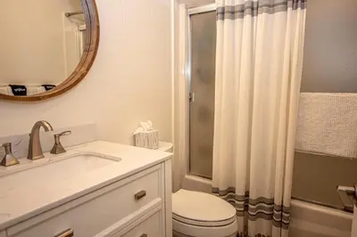a bathroom with a toilet and a sink and a mirror at Price Haus By Hauserman Rentals in Tahoe City