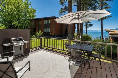 a patio with a table and an umbrella and a grill at Star Harbor # 6 By Hauserman Rentals in Tahoe City