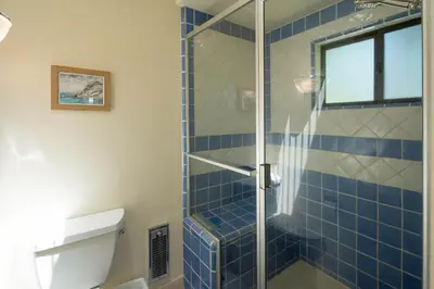a bathroom with a shower with blue tiles at Star Harbor # 6 By Hauserman Rentals in Tahoe City