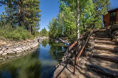 a river with stairs next to a house at Star Harbor # 6 By Hauserman Rentals in Tahoe City