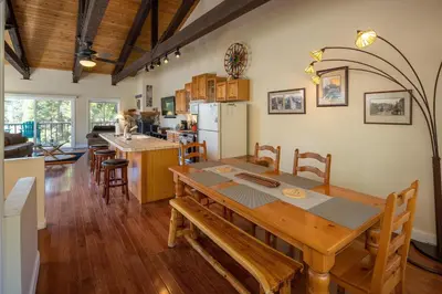 a kitchen and dining room with a wooden table and chairs at Dollar Hill II # 25 By Hauserman Rentals in Tahoe City
