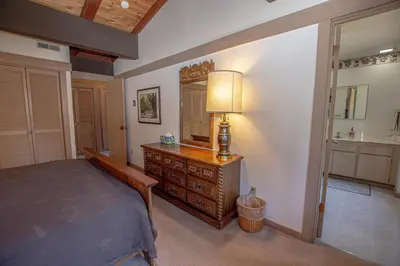 a bedroom with a bed and a dresser and a mirror at Rocky Ridge # 04 By Hauserman Rentals in Tahoe City