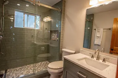a bathroom with a toilet and a shower and a sink at Knobcone Cabin by Hauserman Rental Group in Tahoma