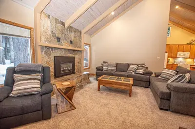 a living room with two couches and a fireplace at Knobcone Cabin by Hauserman Rental Group in Tahoma