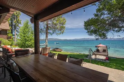 an outdoor dining room with a view of the water at Peaceful Waters By Hauserman Rentals in Tahoma